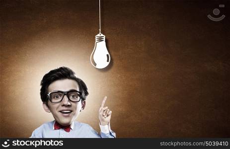 Man of great mind. Idea concept with businessman with big head and light bulb hanging above
