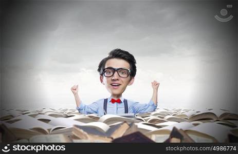 Man of great mind. Young funny man in glasses with big head among pile of old books