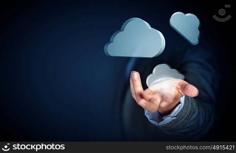Man offering cloud computing concept. Close view of businessman showing cloud icons in palm