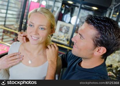 Man offering his girlfriend some jewellery