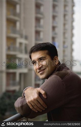 Man on a balcony smiling