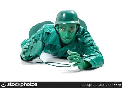 Man on a green toy soldier costume, crawling with binocolous isolated on white background.