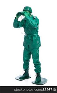 Man on a green toy soldier costume standing with binocolous isolated on white background.