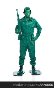 Man on a green toy soldier costume standing with riffle isolated on white background.