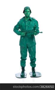 Man on a green toy soldier costume with riffle isolated on white background.