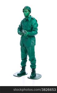 Man on a green toy soldier costume with riffle isolated on white background.