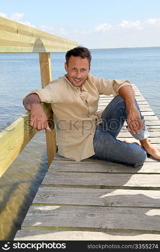 Man on a pontoon by a lake in summer