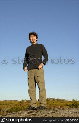 man on a rock and the sky as background