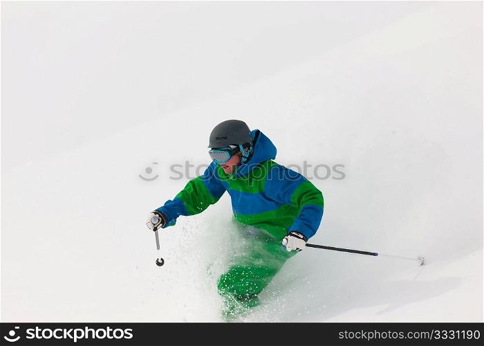 Man on a ski track going downhill, very beautiful alpine mountains