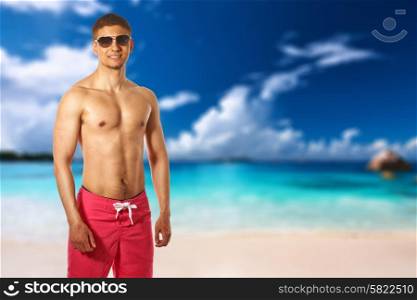 Man on beach at Seychelles, Praslin, Anse Lazio. Collage.