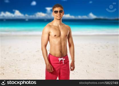 Man on beach at Seychelles, Praslin, Anse Lazio. Collage.
