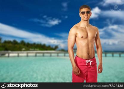 Man on beach with jetty at Maldives. Collage.