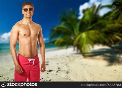 Man on beach with palm tree at Seychelles, Praslin, Cote d&rsquo;Or. Collage.