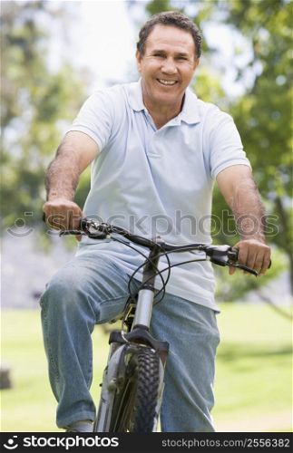 Man on bike outdoors smiling