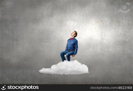Man on cloud. Emotional businessman sitting in chair on cloud