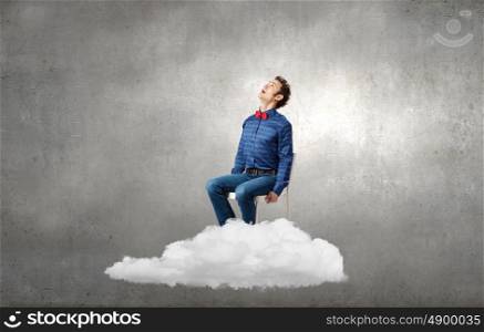 Man on cloud. Emotional businessman sitting in chair on cloud