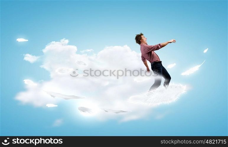 Man on cloud. Young man walking on cloud high in sky