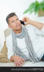 Man on couch on telephone