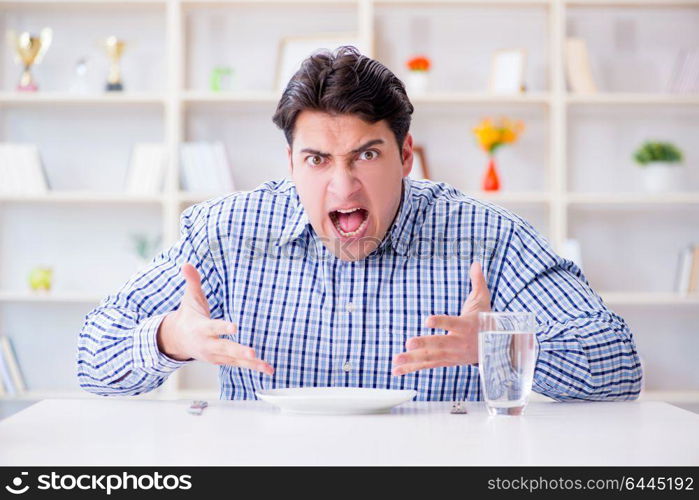 Man on diet waiting for food in restaurant