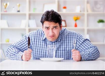 Man on diet waiting for food in restaurant