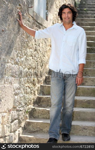 Man on holiday next to old building