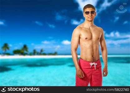 Man on island beach with sandspit at Maldives. Collage.