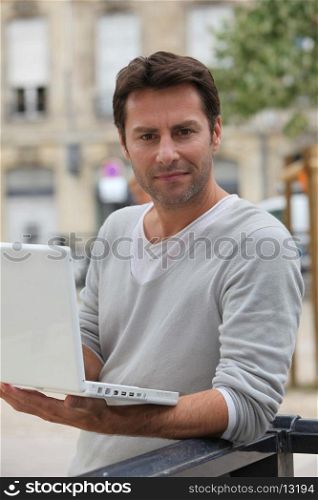 Man on laptop outside