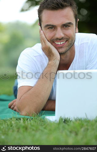 Man on laptop outside