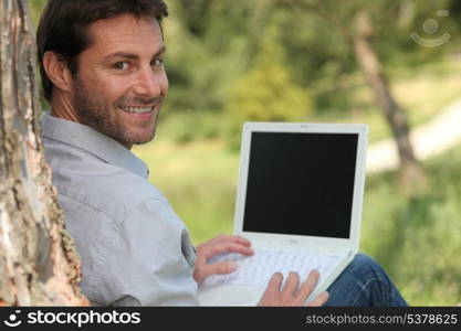 Man on laptop outside