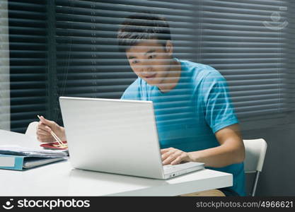 Man on laptop with takeaway