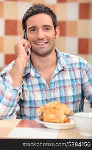 Man on phone at breakfast