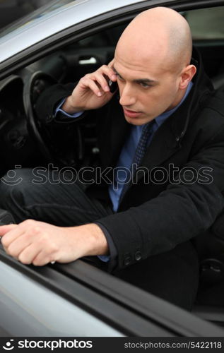 Man on phone getting out of his car