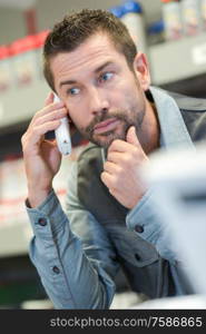 man on phone in a storage area