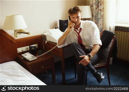 Man on Phone in Hotel Room