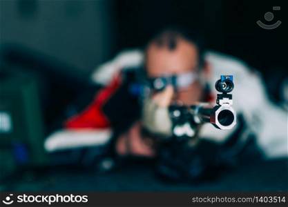 Man on sport shooting training practicing for competition with free rifle
