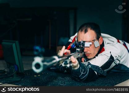 Man on sport shooting training practicing for competition with free rifle