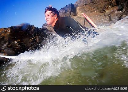 Man on surfboard in splashing water
