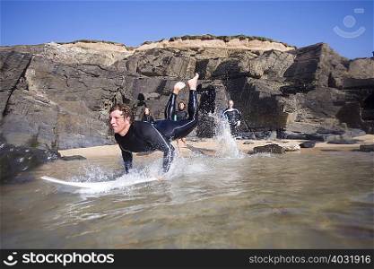 Man on surfboard with three surfers