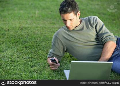 Man on the grass with laptop