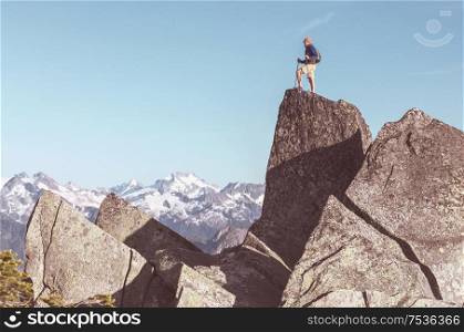 Man on the mountains cliff. Hiking scene.