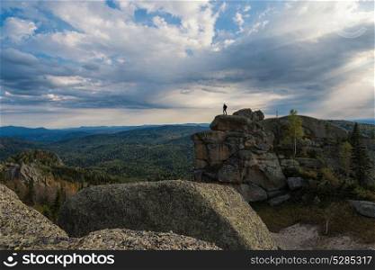 Man on the peak of mountains of Altai. Kolyvan range - a mountain range in the north-west of the Altai Mountains, in the Altai Territory, Russia. Man on the peak in mountains