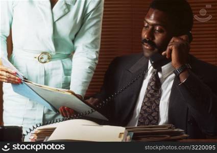 Man on the Phone at Desk