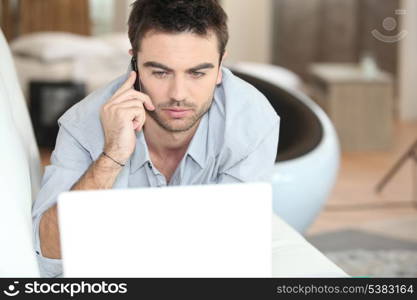 Man on the phone at the computer