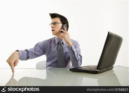 Man on the phone with a computer