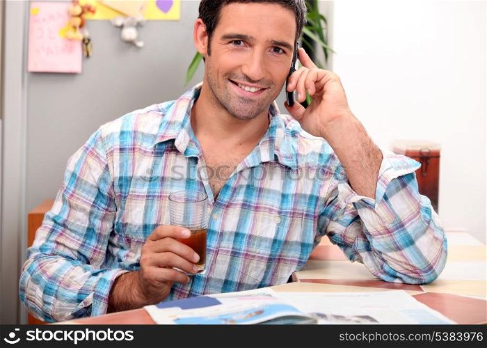 Man on the telephone having breakfast