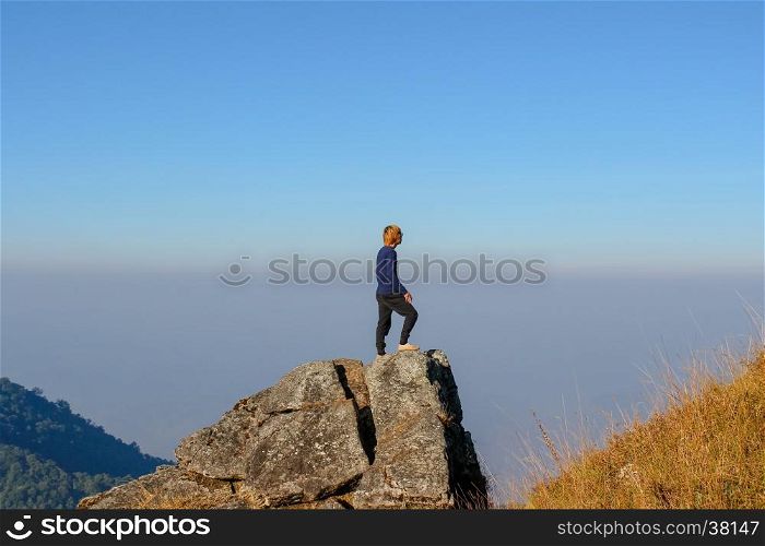 Man on the top of the hill watching wonderful scenery in mountains during summer colorful in Thailand. Vintage filtered image.