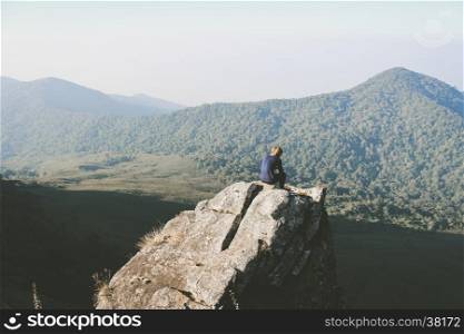 Man on the top of the hill watching wonderful scenery in mountains during summer colorful in Thailand. Vintage filtered image.