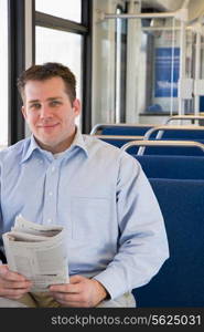 Man on train with newspaper