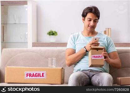 Man opening fragile parcel ordered from internet