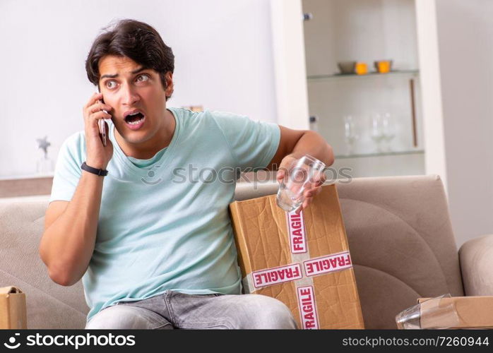 Man opening fragile parcel ordered from internet